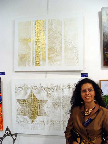 Einat with her works at the exhibition